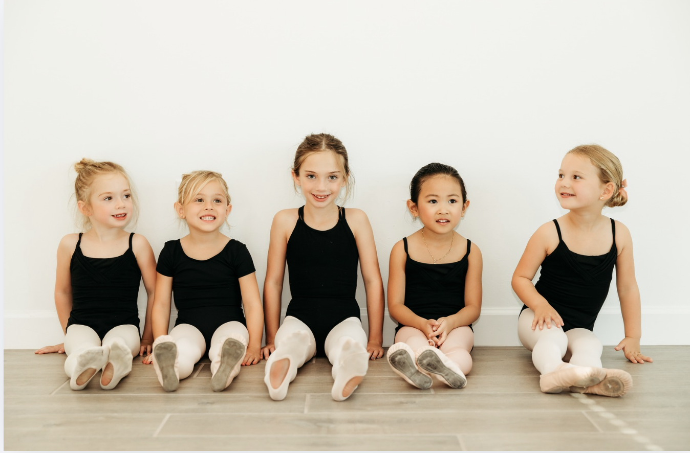 young ballerinas sit on the floor of The Dance Lounge studio in Fort Myers, FL